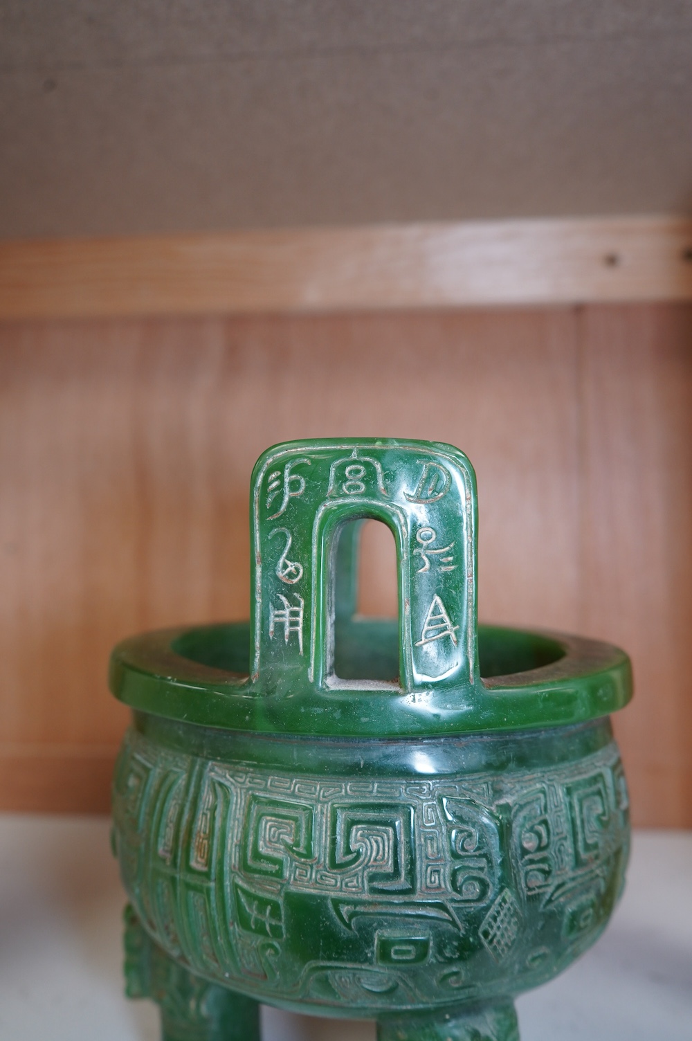 A Chinese green glass tripod censer, 20cm high. Condition - fair